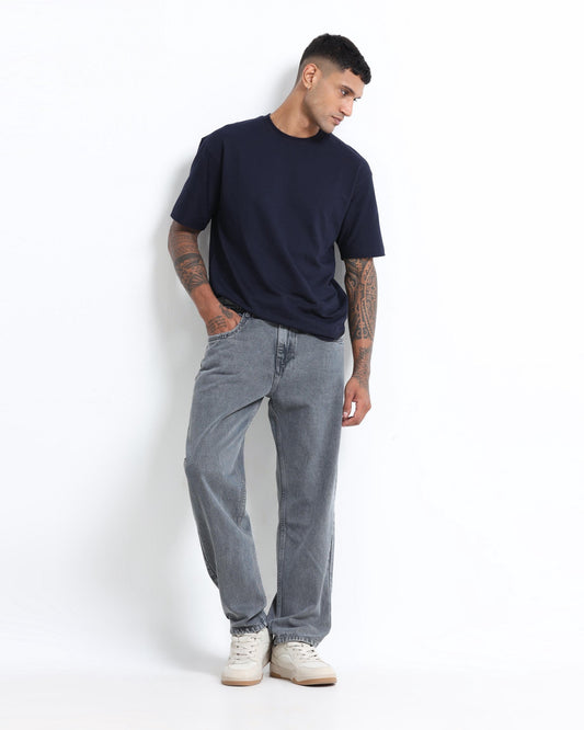 Man wearing a white shirt with ash grey straight fit jeans — grey jeans combination shirt