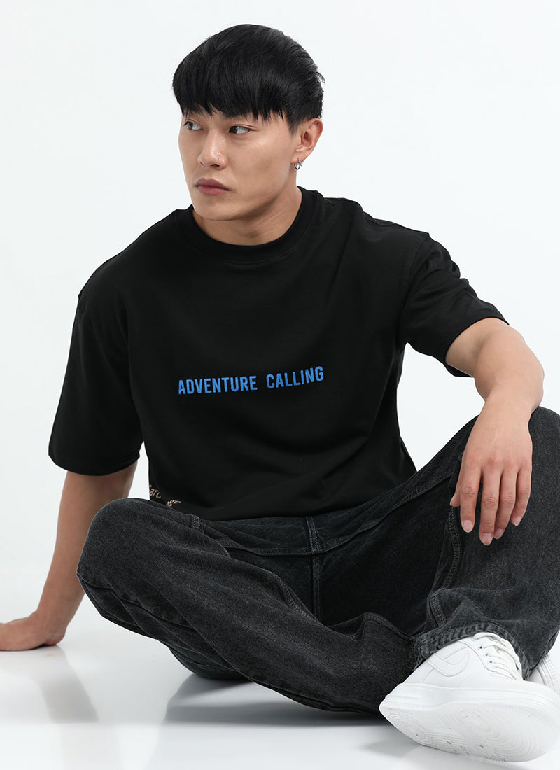 LIFE IS GOOD Oversized Cotton Printed T-Shirt Carbon Black - Sitting Pose View